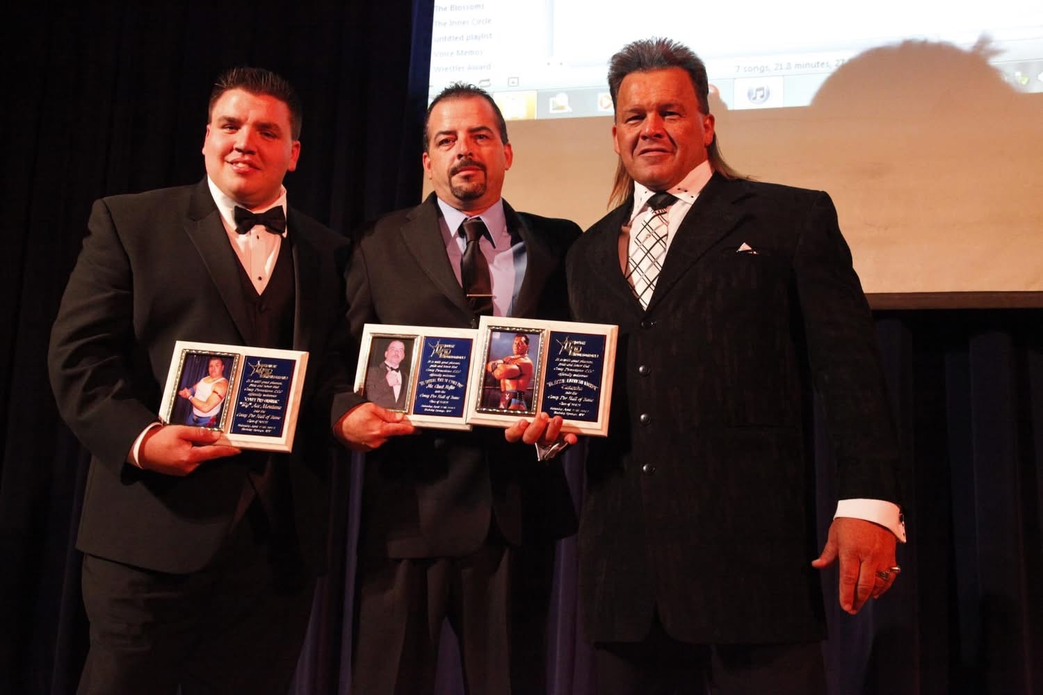 Hall of Fame induction ceremony — Big Ace Montana (left), Chuck Heflin Youngblood (center), Tatanka (right) holding their induction plaques